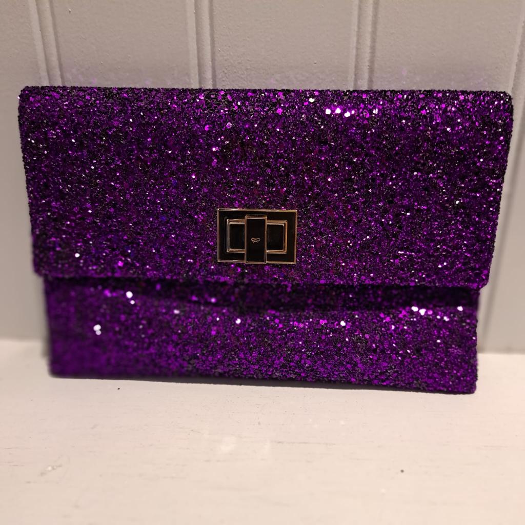 Purple glitter clutch bag top